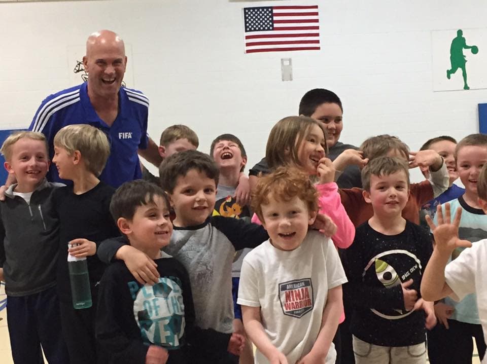 Coach Jim Evans coaching youths of elementary and middle ages